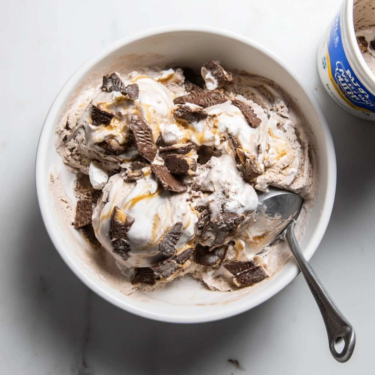 Dark chocolate Ninja Creami Phish Food dessert featuring caramel drizzle and marshmallow swirls on a white plate