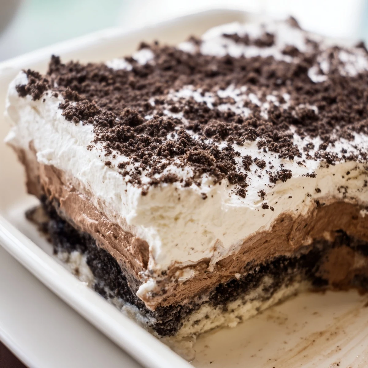 Creamy no-bake keto dirt cake showing chocolate pudding layers beneath dark chocolate almond soil