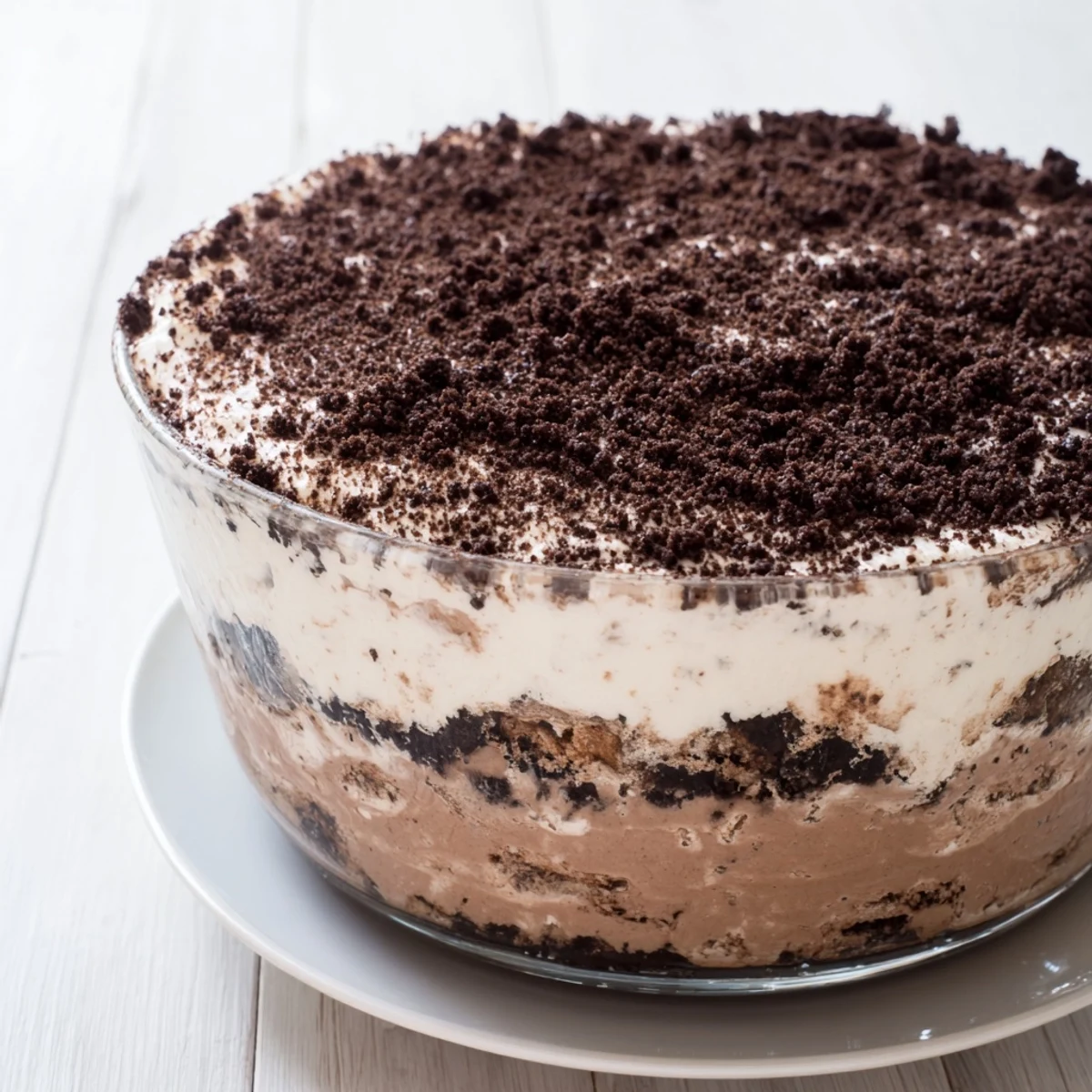 Sliced keto dirt cake revealing fluffy whipped cream sandwiched between rich chocolate pudding and crumble