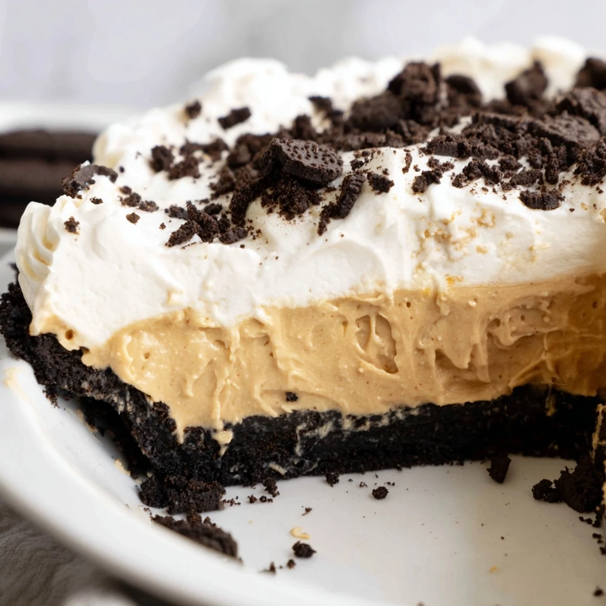 Sliced peanut butter Oreo pie showing thick creamy filling in dark crust
