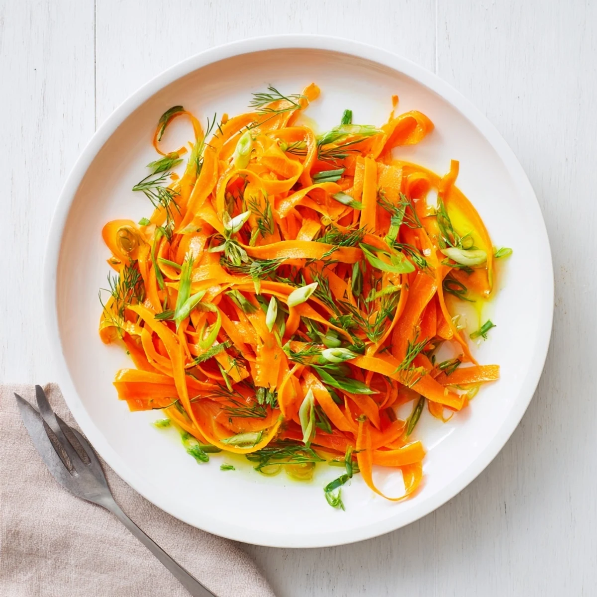 Crisp marinated carrot salad glistening with lemon dill dressing in a bright serving bowl