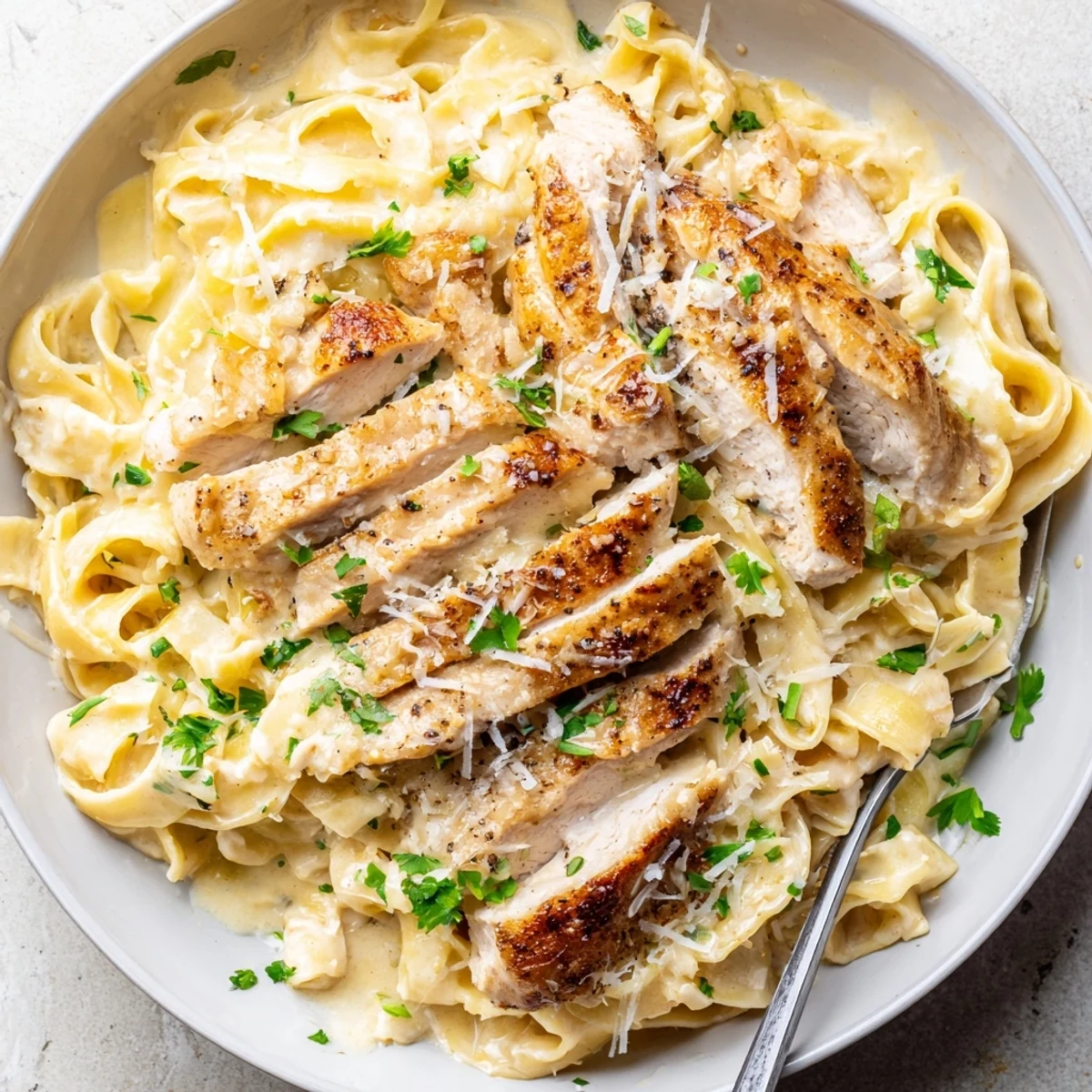 A bowl of Creamy Garlic Chicken Pasta, silky sauce coating tender chicken