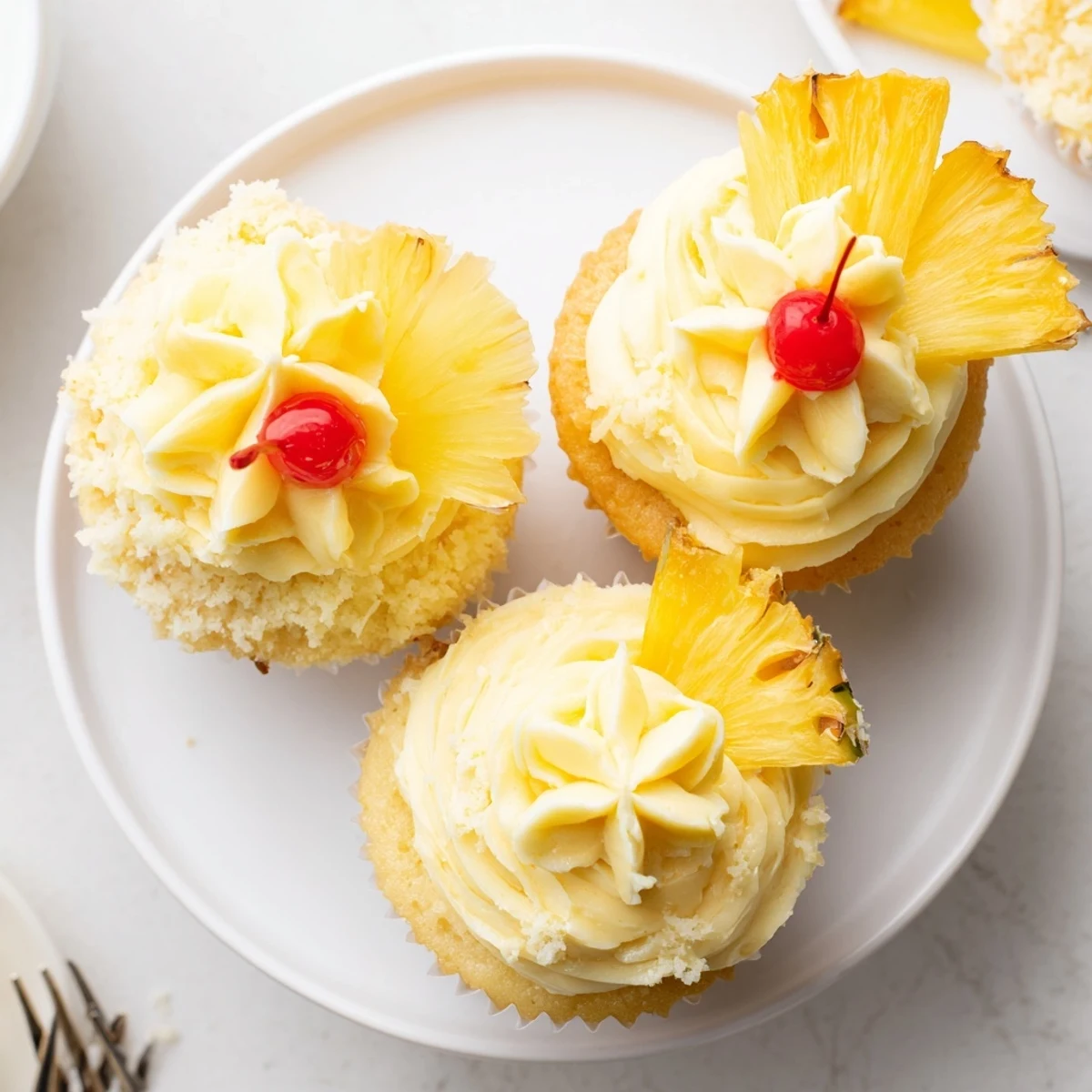 Classic Dole Whip Cupcakes Recipe served with dried pineapple flowers and cherries