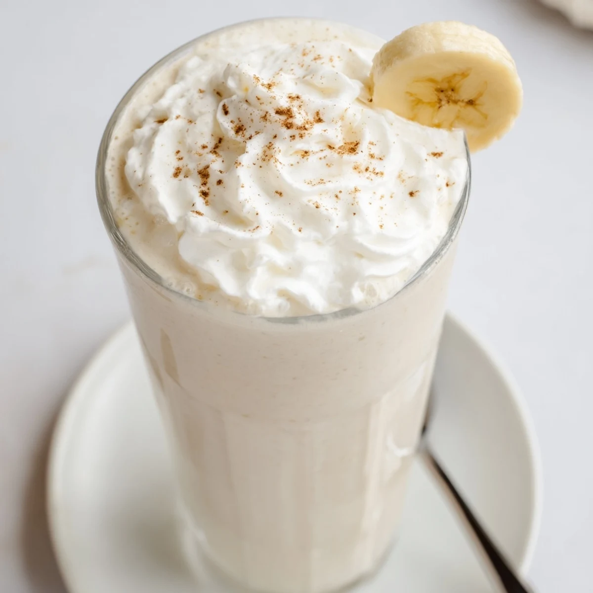 Cool, sweet Vanilla Banana Shake blended with maple syrup, sprinkled cinnamon