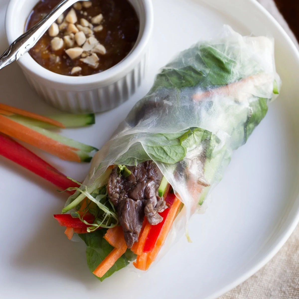Sliced Thai Basil Beef Rolls arranged on board, tender beef and fresh basil.