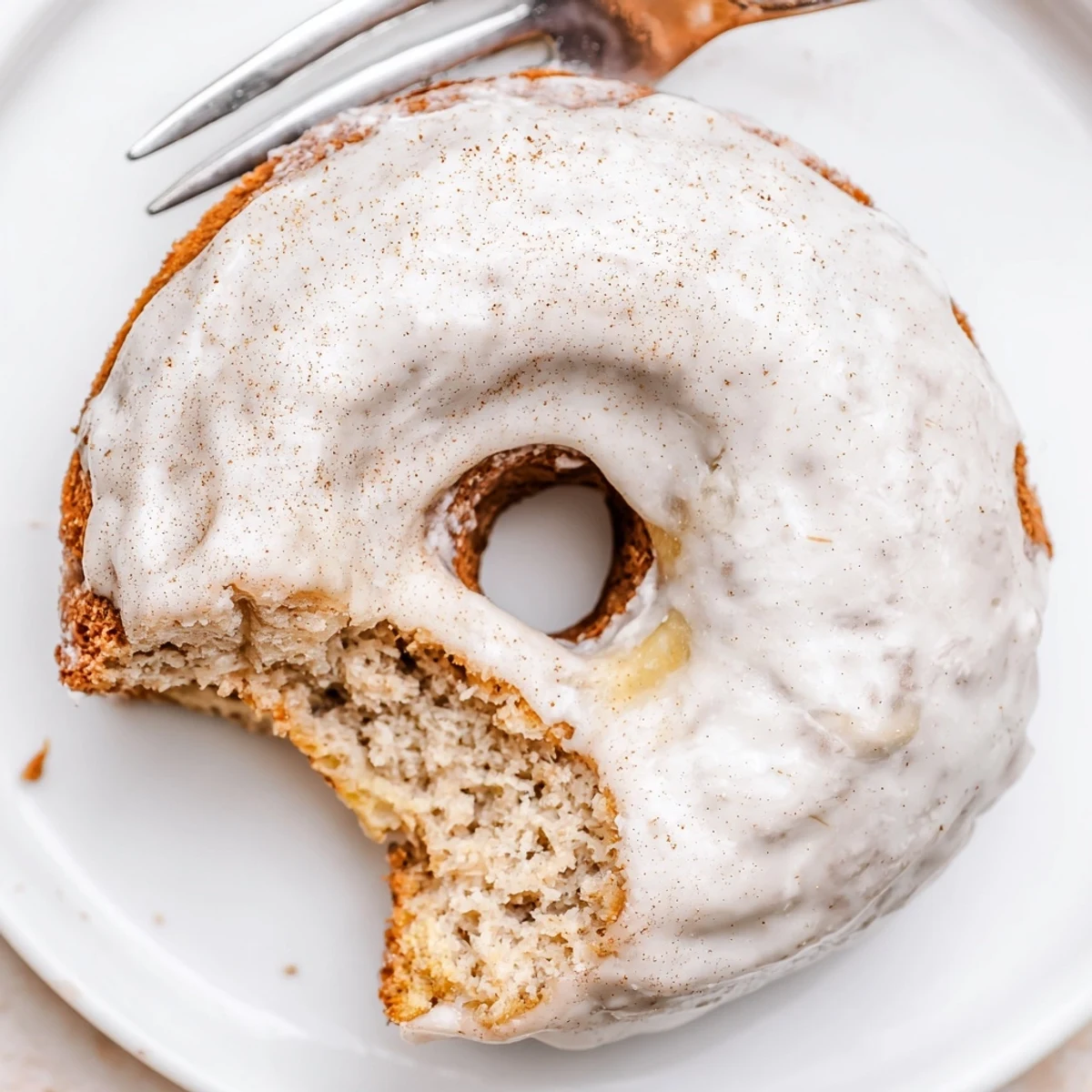 Plate of fluffy Banana Donuts sliced to reveal soft, cake-like interior