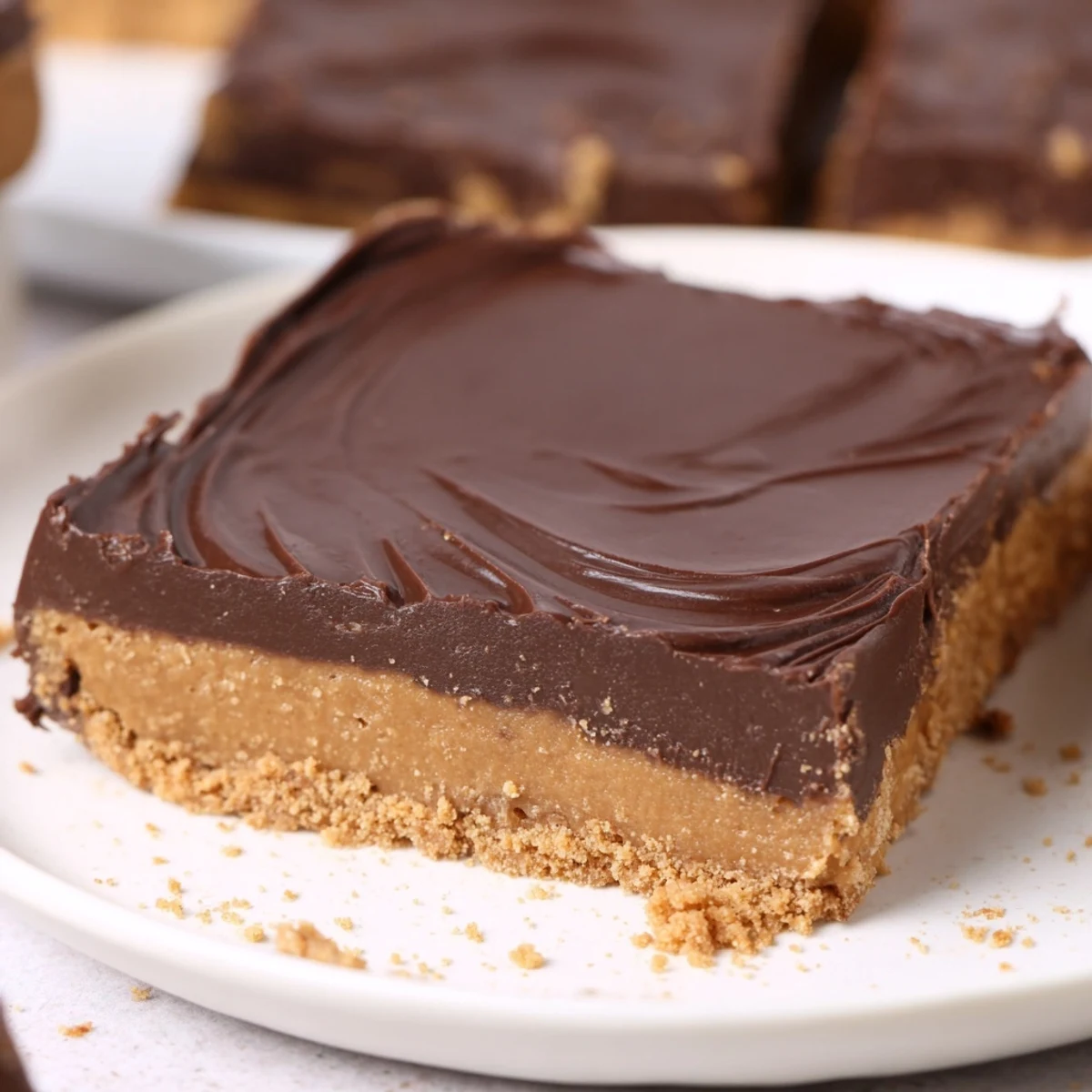No Bake Peanut Butter Bars chilled and glossy, sliced on parchment, ready to serve