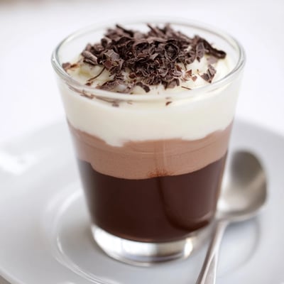 Chilled Triple Chocolate Mousse Cups topped with shaved chocolate and cocoa dust